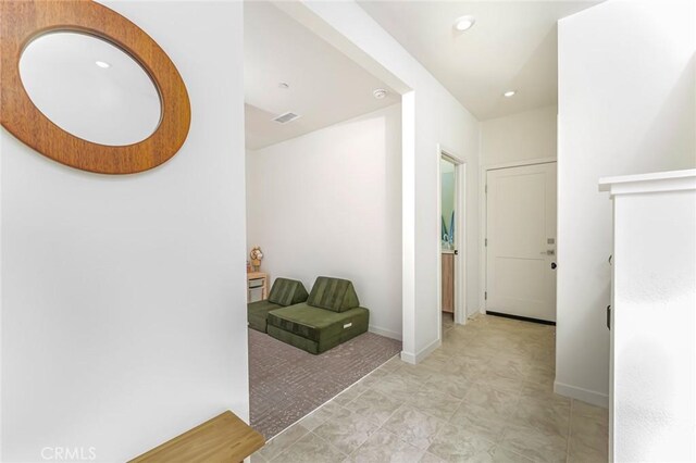 hall featuring light tile patterned floors