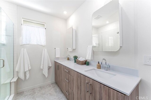 bathroom with vanity, tile patterned floors, and a shower with door