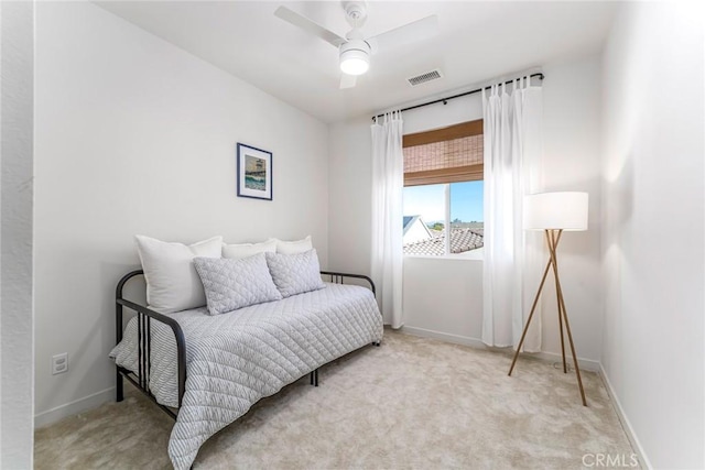 bedroom with light carpet and ceiling fan