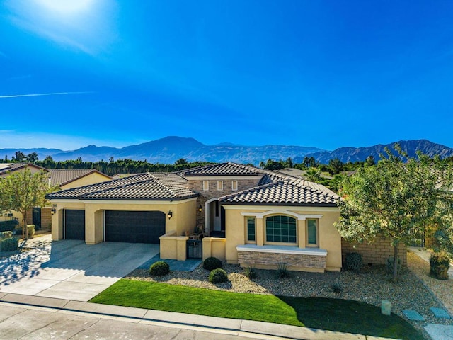 view of front of home featuring a garage and a mountain view