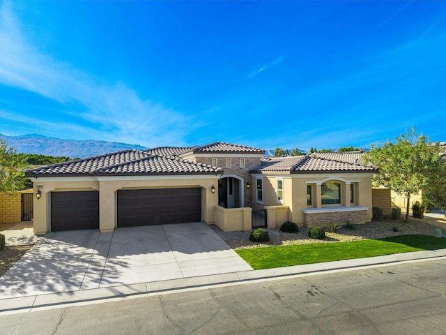 mediterranean / spanish house featuring a mountain view and a garage