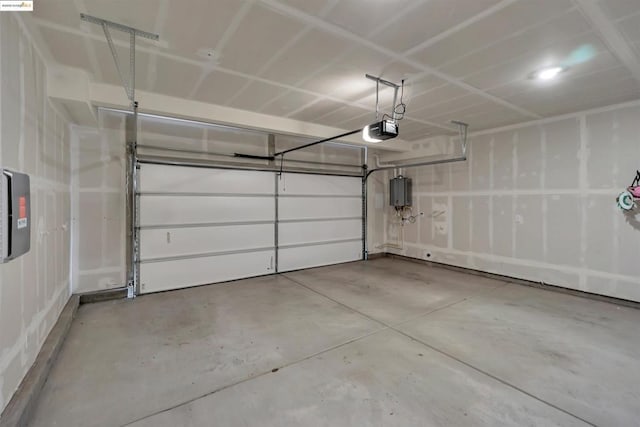 garage with a garage door opener and electric panel