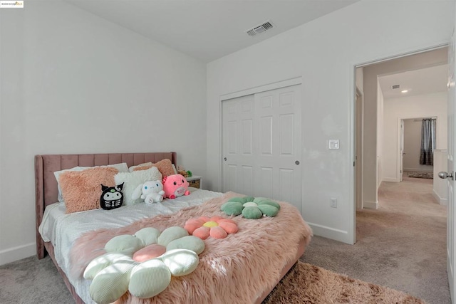 bedroom with a closet and light colored carpet