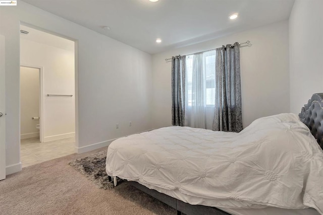 carpeted bedroom with ensuite bath