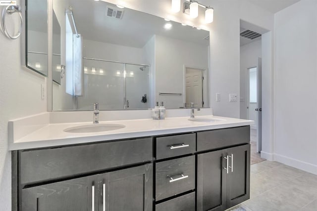 bathroom featuring vanity, tile patterned flooring, and a shower with door