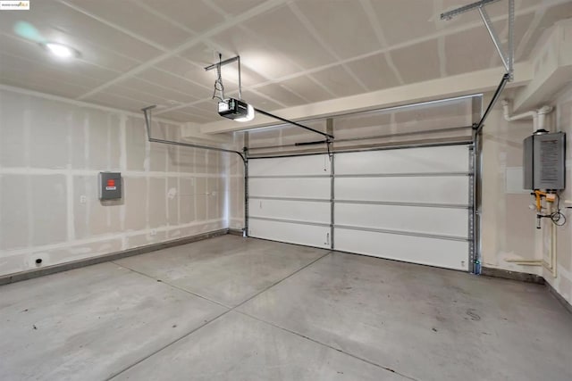 garage featuring water heater and a garage door opener