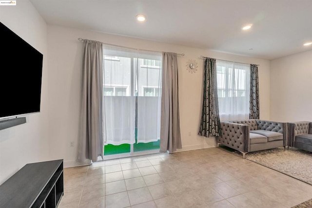 unfurnished living room featuring light tile patterned floors