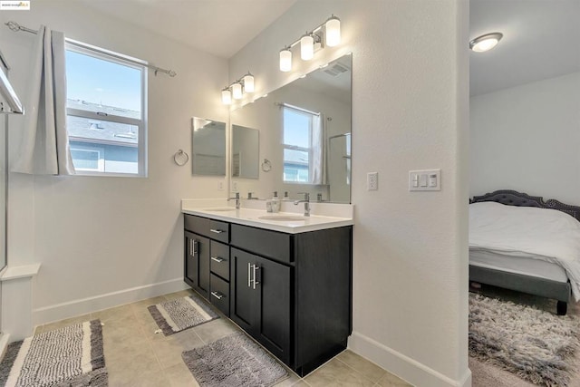 bathroom featuring a healthy amount of sunlight, vanity, and tile patterned floors