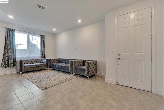 unfurnished living room with light tile patterned floors