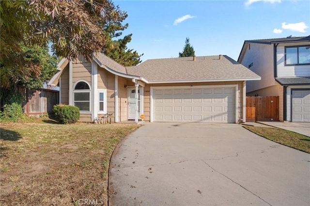 view of front of home with a front yard and a garage