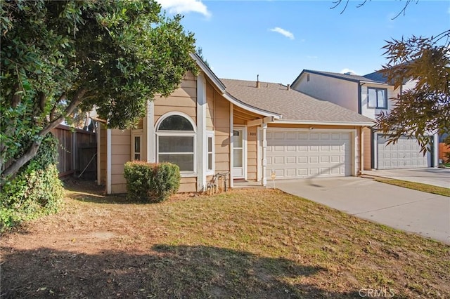 view of front of house featuring a garage and a front lawn