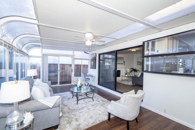 living room with hardwood / wood-style floors and ceiling fan