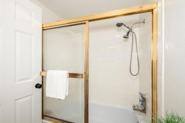 bathroom featuring shower / bath combination with glass door