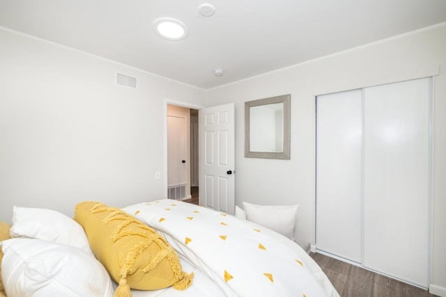 bedroom featuring hardwood / wood-style floors and a closet