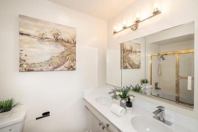 full bathroom with vanity, combined bath / shower with glass door, and toilet