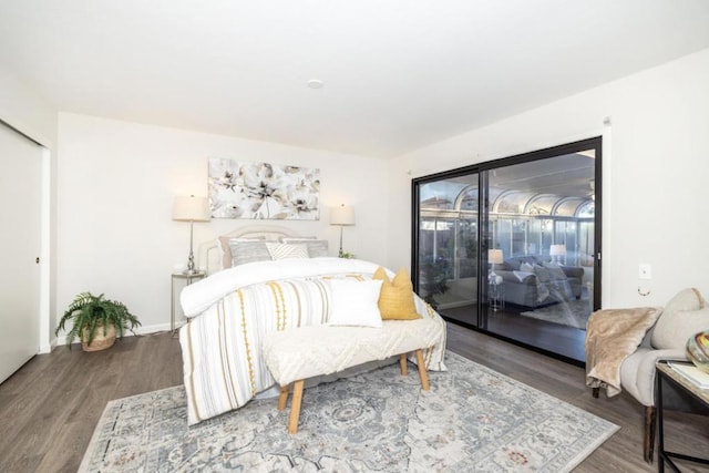 bedroom with wood-type flooring and access to outside