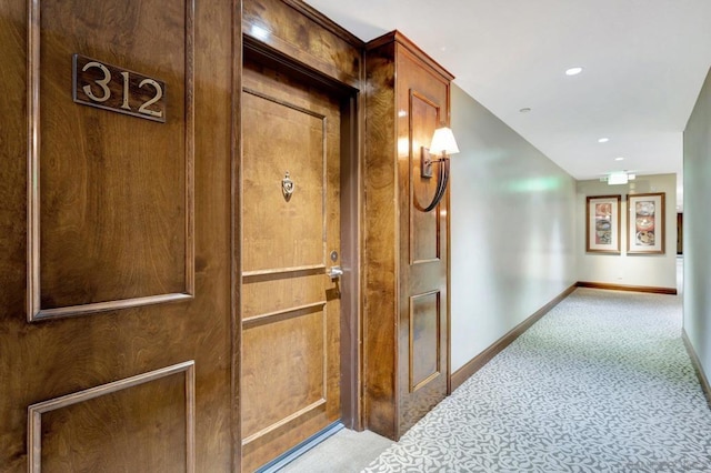 hallway featuring light colored carpet