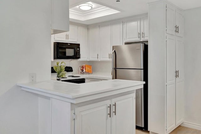 kitchen with white cabinetry, kitchen peninsula, stainless steel refrigerator, ornamental molding, and white range