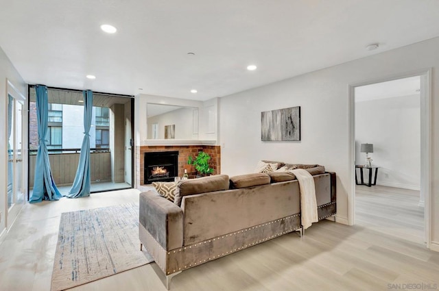 living room featuring light hardwood / wood-style flooring and a fireplace