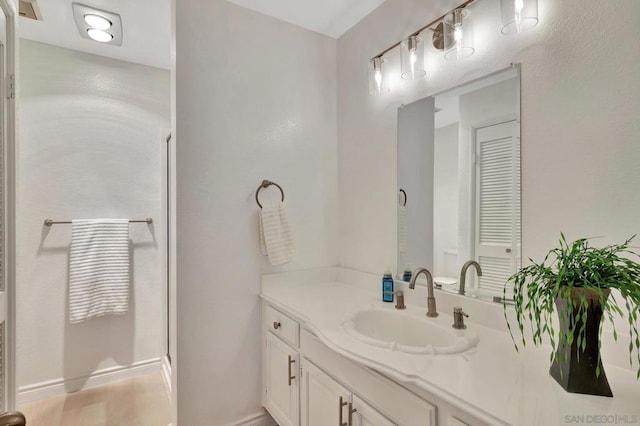 bathroom featuring a shower with shower door, vanity, and wood-type flooring