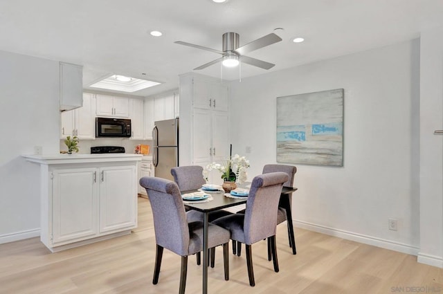 dining space featuring ceiling fan and light hardwood / wood-style flooring