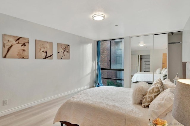 bedroom with hardwood / wood-style floors and a closet