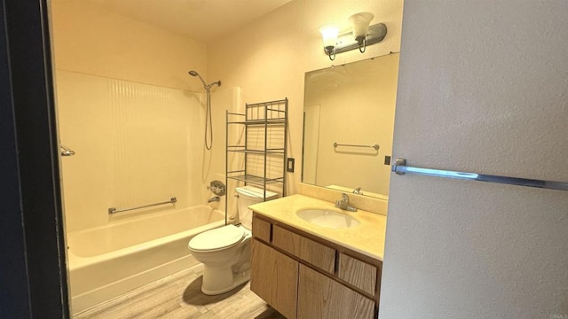 full bathroom with shower / bathing tub combination, hardwood / wood-style floors, vanity, and toilet