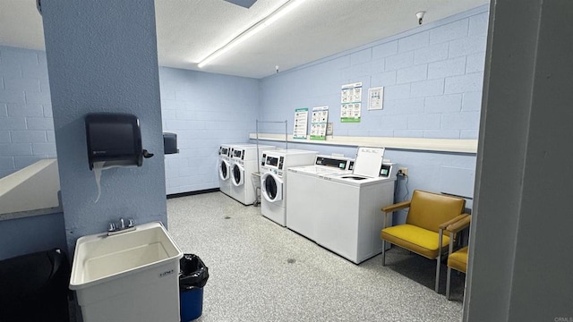 3776 Alabama St Unit 318, San Diego, CA 92104 - community laundry with washer and clothes dryer, concrete block wall, and a textured ceiling