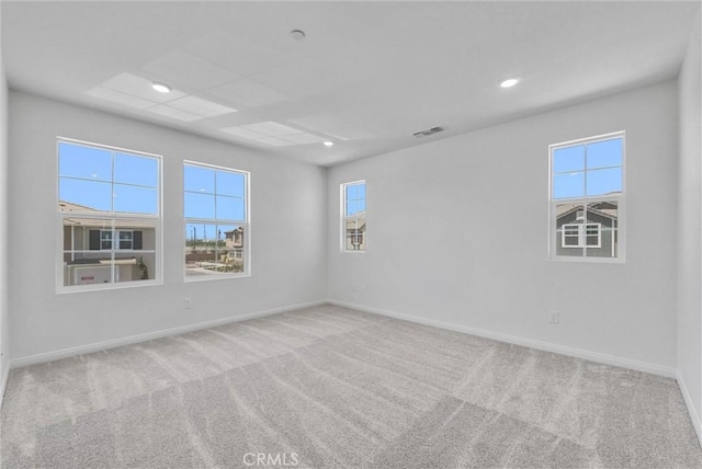 spare room featuring light colored carpet