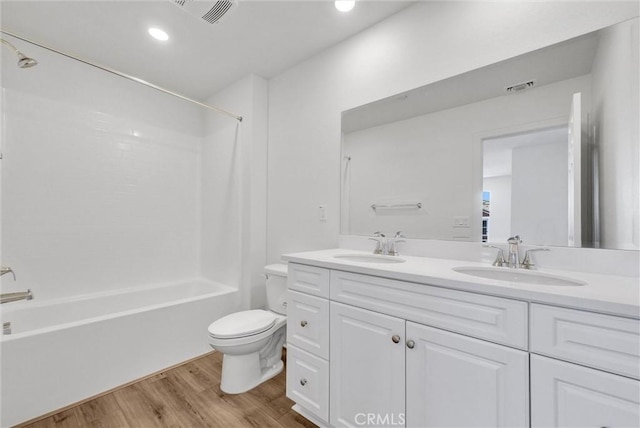 full bathroom with toilet, bathtub / shower combination, vanity, and hardwood / wood-style floors