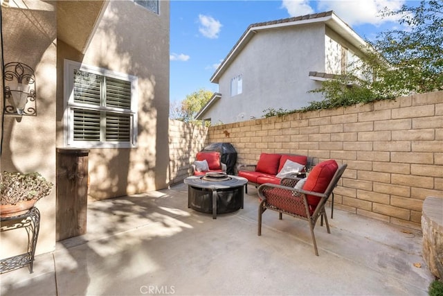 view of patio / terrace with an outdoor living space with a fire pit