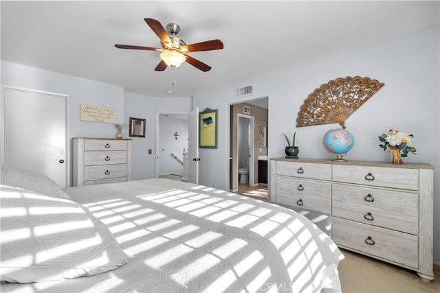 carpeted bedroom featuring ceiling fan and ensuite bathroom