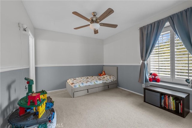 bedroom with ceiling fan and light carpet