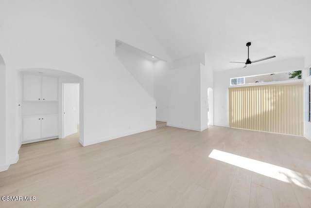 unfurnished living room with ceiling fan, light hardwood / wood-style flooring, and high vaulted ceiling