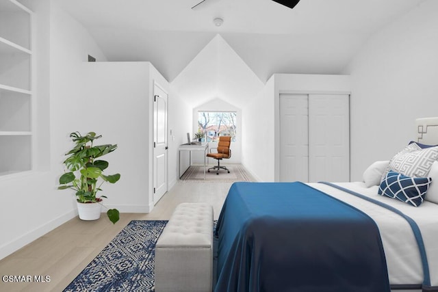 bedroom featuring ceiling fan, lofted ceiling, light hardwood / wood-style floors, and a closet