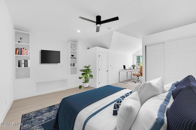 bedroom with ceiling fan, light hardwood / wood-style flooring, a closet, and vaulted ceiling