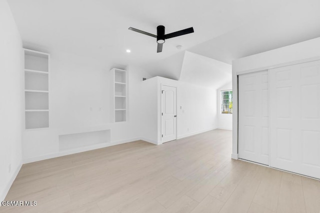 interior space featuring ceiling fan, lofted ceiling, and light hardwood / wood-style floors