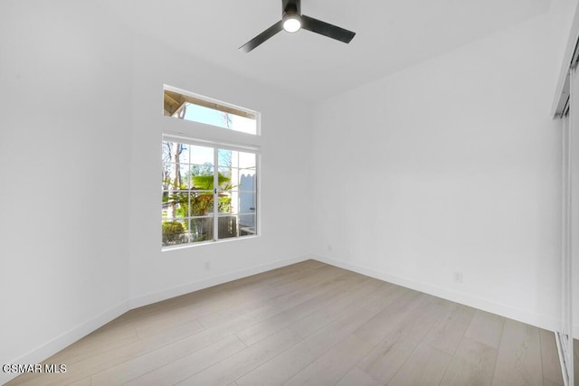 empty room with ceiling fan and light wood-type flooring