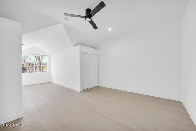 additional living space with ceiling fan, lofted ceiling, and light wood-type flooring