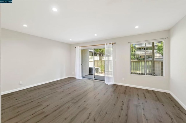 spare room with dark wood-type flooring