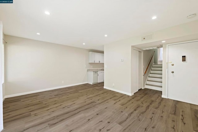 unfurnished living room featuring hardwood / wood-style flooring