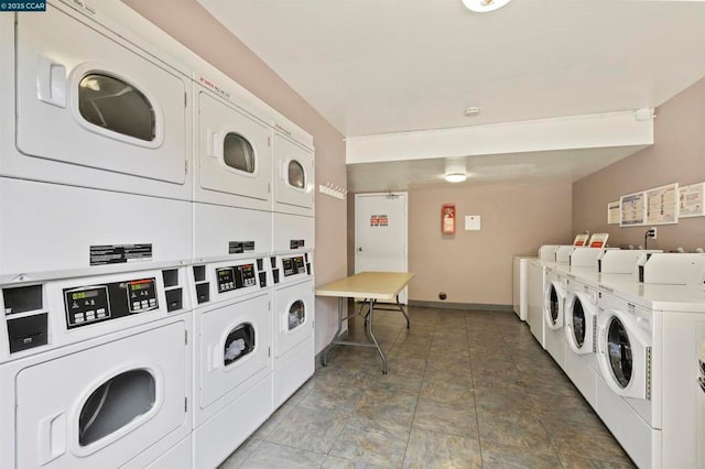 clothes washing area with washer and clothes dryer and stacked washer and clothes dryer