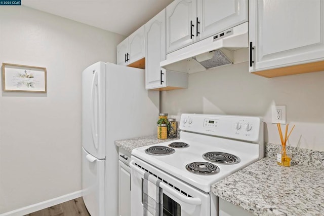 kitchen with hardwood / wood-style floors, white cabinets, light stone counters, and electric stove