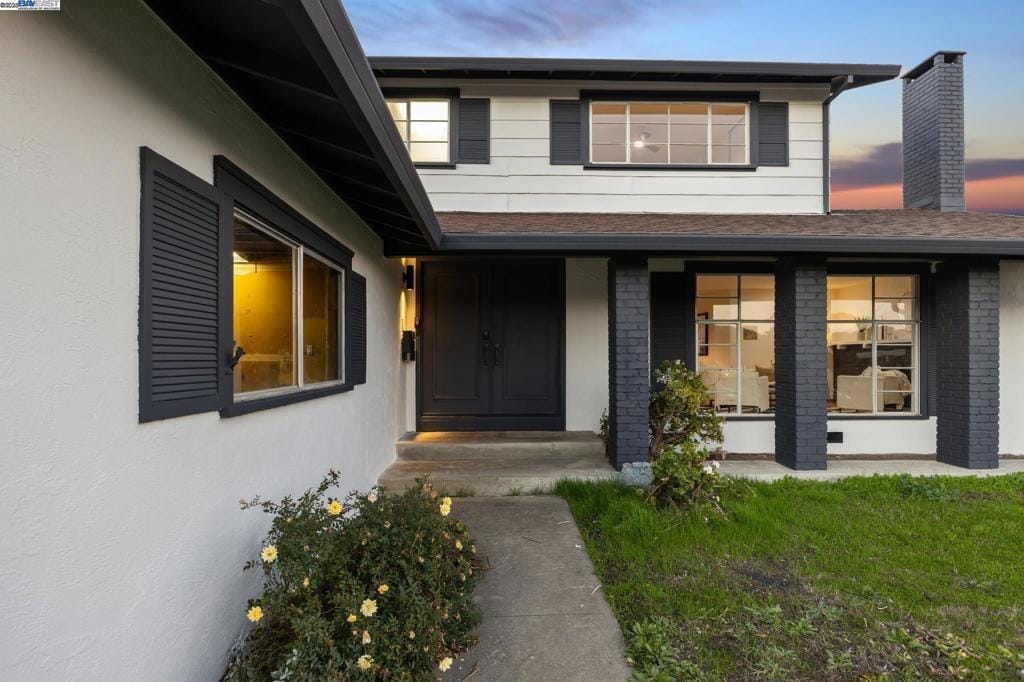 exterior entry at dusk with a yard