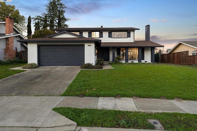 view of front of house featuring a garage, a porch, and a lawn