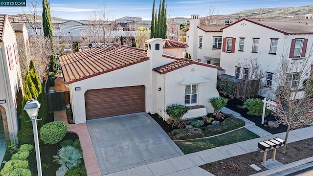 mediterranean / spanish-style house with a garage