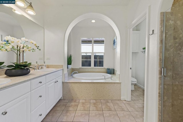 full bathroom featuring toilet, vanity, separate shower and tub, and tile patterned floors