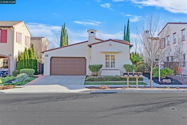 mediterranean / spanish home featuring a garage