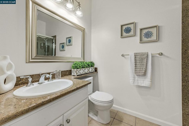 bathroom featuring toilet, vanity, and tile patterned floors