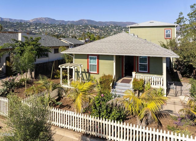 view of front facade featuring a mountain view and covered porch